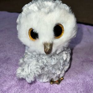 TY beanie baby owlette colors grey, white, and some light brown.